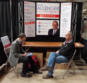Steve Allender (right) takes a break from setting up his Home Show booth to talk with Dakota Free Press, 2015.03.26