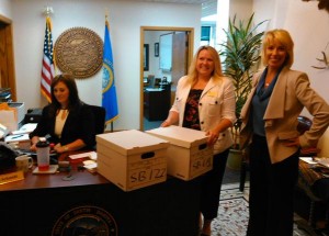 Secretary of State Shantel Krebs (right) and Deputy SOS Kea Warne (middle) receive petitions to refer SB 177 and SB 69. State Capitol, Pierre, South Dakota, 2015.06.29