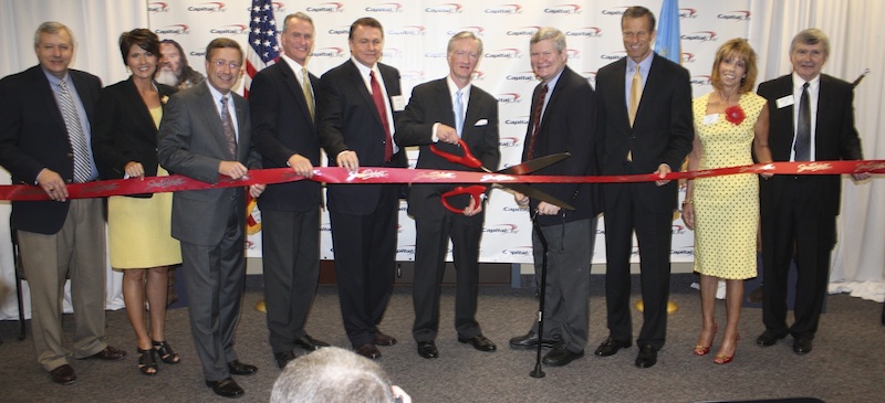Capital One Sioux Falls ribbon cutting: (L to R) Slater Barr, U.S. Rep. Kristi Noem, Mayor Mike Huether, Gov. Dennis Daugaard, Curt Milroy (VP, Operations), Dan Mortensen (SVP, corporate real estate & HR operations), U.S. Sen. Tim Johnson, U.S. Sen. John Thune, Barb Stork and Evan Nolte. Photo from Sioux Falls Area Chamber of Commerce, May 2012.