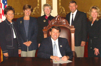 Standing around for pictures to make Mike look good—Governor Rounds signs executive order creating Interagency Council on Homelessness, 2003.09.25. Photo from HUD.