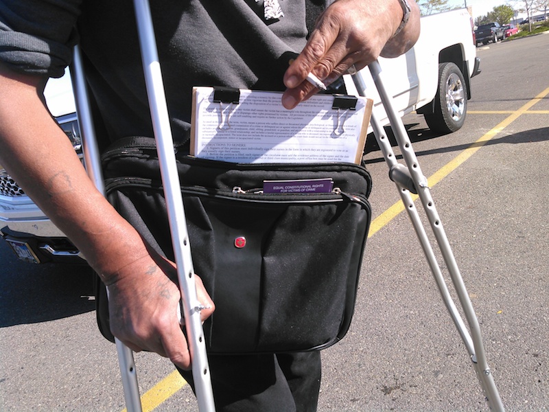 Circulator's bag, with petition on clipboard and purple Marsy's Law flyer.