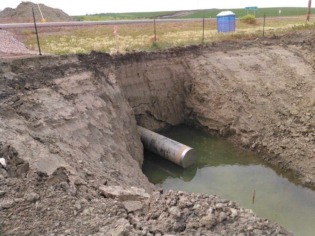 Dakota Access pipe under Highway 19, partially in standing water, 2016.06.25.