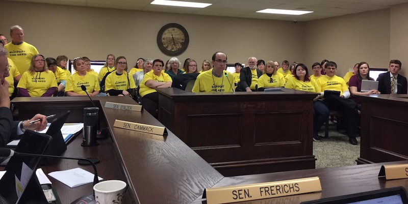 Supporters of SB 169 in yellow t-shirts (including tax-hike sponsor Sen. Al Novstrup, in yellow t-shirt at far right), Senate Taxation, 2017.02.15. Photo tweeted by Sen. Jason Frerichs.