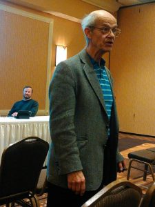 Dr. Harwood Schaffer, Agricultural Policy Analysis Center, addresses a couple-three dozen ag producers at the Dakota Event Center, Aberdeen, South Dakota, while event host and South Dakota Farmers Union president Doug Sombke (background) looks on. Photo by CAH, 2017.03.20.