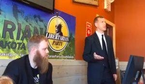 Kurt Evans debates CJ Abernathey at the Libertarian Party of South Dakota Convention 2.0, Pierre, SD, 2018.06.09. Screen cap from CJ Abernathey's FB video stream.
