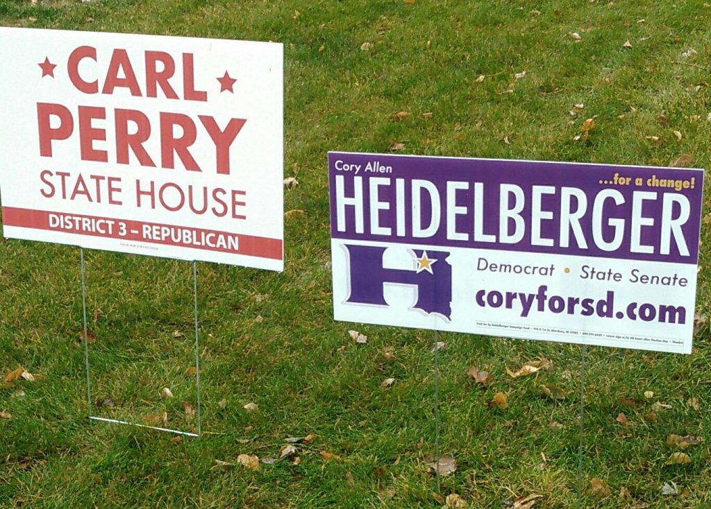 Signs for Republican Carl Perry and Democrat Cory Allen Heidelberger in an Aberdeen, South Dakota, yard, 2018.11.03