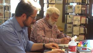 Stan Adelstein and biography author Eric Zimmer, signing books at Mitzi's in Rapid City, from KNBN TV, 2019.09.01.
