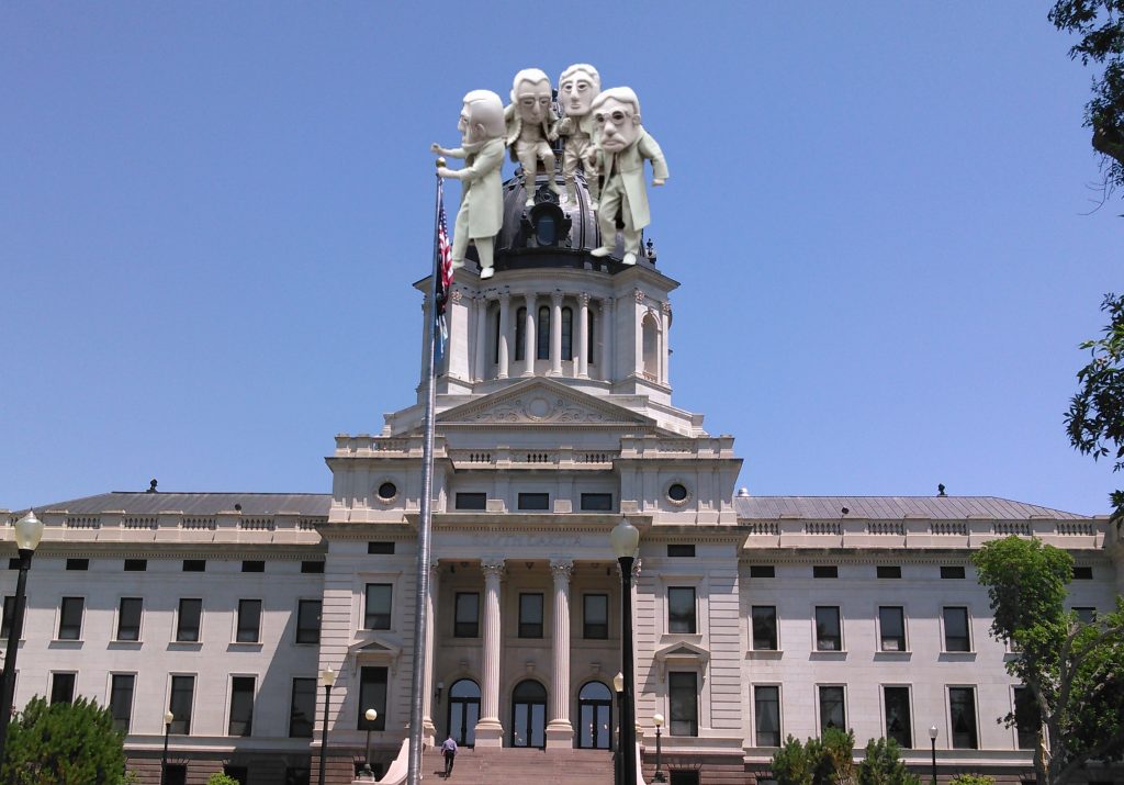 Rushmore Singing Statutes atop South Dakota Capitol: A Proposal