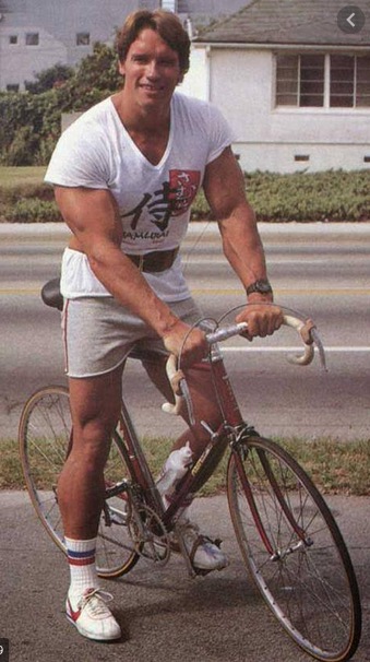 Arnold Schwarzenegger on bicycle, c. 1970