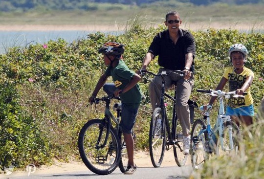Barack Obama and daughter on bicycles