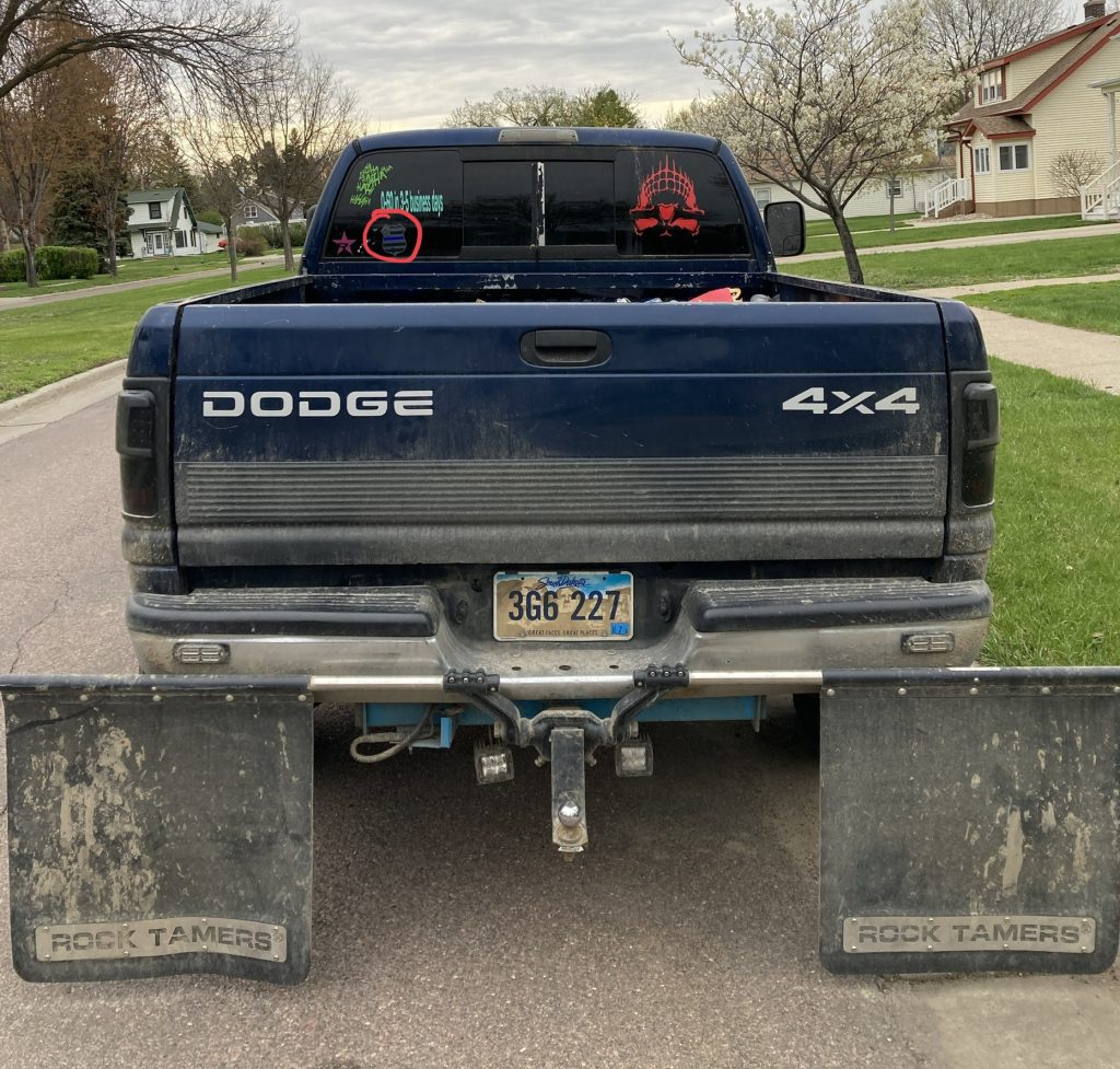 Blue Lives Matter decal, highlighted among other things blocking this man’s view, Aberdeen, SD, 2021.05.08.