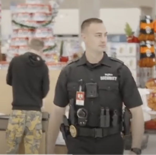 Walks right by the guy in camo pants—come on, Hy-Vee Security! Keep your eyes open for domestic terrorists! Hy-Vee promotional video, posted by Minnesota News Now, YouTube, 2021.12.29.