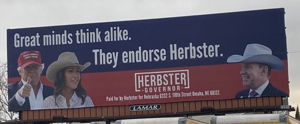 Billboard promoting Donald Trump's and Kristi Noem's endorsements of Charles Herbster for Nebraska Governor, along Highway 2, Lincoln, NE, photo taken 2022.04.03.