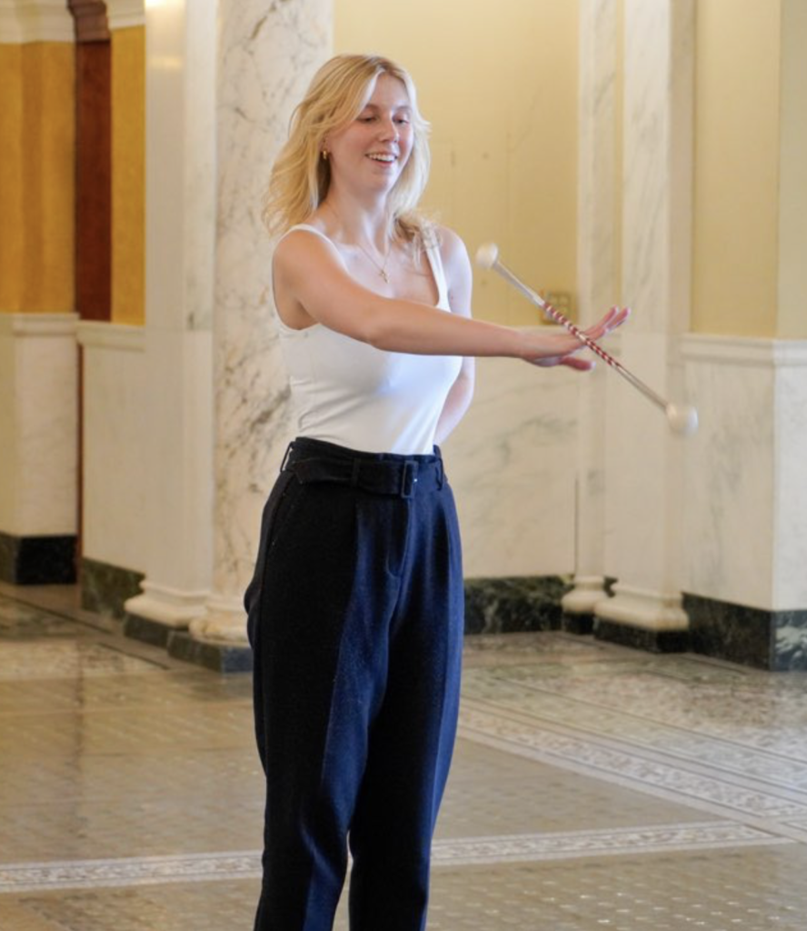 Governor's press secretary Amelia Joy twirls her baton in the Capitol Rotunda; tweet by Gov. Kristi Noem, 2023.04.19.