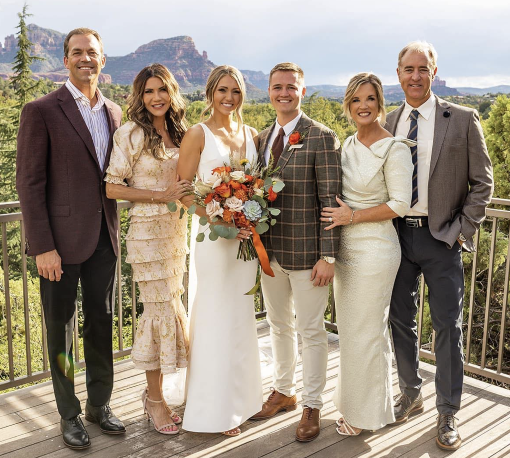 Bryon Noem, Kristi Noem, Kennedy Frick, Tanner Frick, Jodie Frick, and now Transportation Commission member Chris Frick at Kennedy and Tanner's wedding in Sedona, Arizona, 2022.10.07. Photo from Tanner Frick, FB banner pic, posted 2023.05.12.