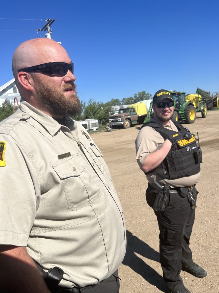 Law enforcement supervising Summit Carbon Solutions drilling and digging on Jared Bossly's land, 2023.06.20.