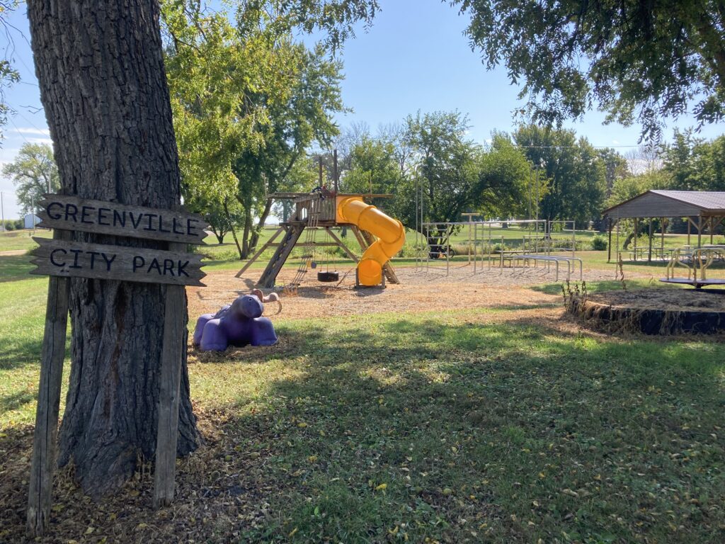 Rest break at Greenville City Park, with the purple dinosaur.