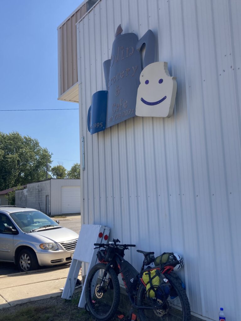 Established 1995… and contrary to the sign, I’m not sure I saw a loaf of bread on the few shelves of bare necessities on the southeast wall inside.