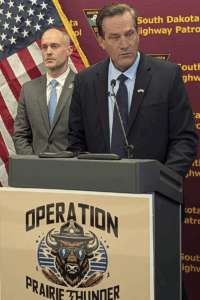 Official "Operation Prairie Thunder" logo on podium at Governor Larry Rhoden's July 28, 2025, press conference. Photo by John Hult, South Dakota Searchlight.